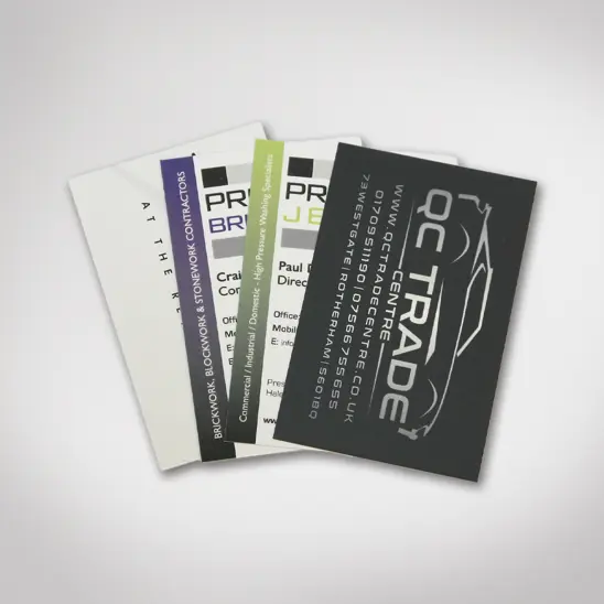 Professionally printed business cards displaying the logo of a car dealership.