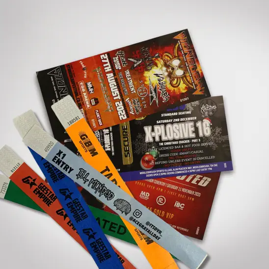 A collection of printed event tickets and wristbands showcasing various types of tickets.